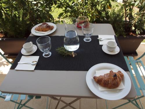 a white table with plates of food on it at B&B Ramerino in Grosseto
