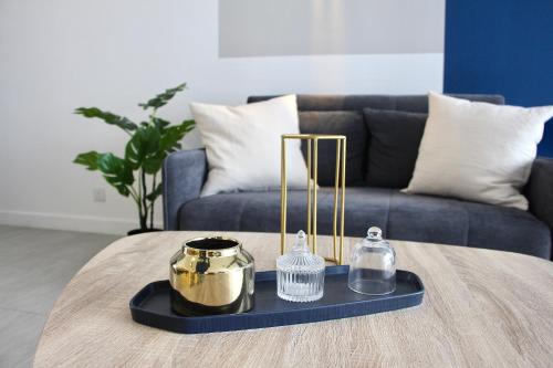 a coffee table in a living room with a blue couch at Bell Suites @ Sunsuria City in Sepang