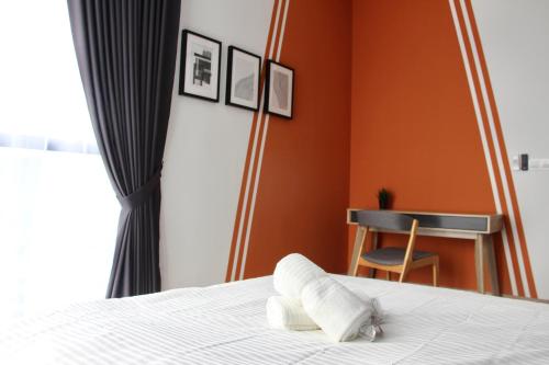 a bedroom with a bed with two pillows on it at Bell Suites @ Sunsuria City in Sepang