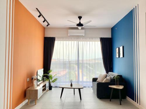a living room with a couch and a large window at Bell Suites @ Sunsuria City in Sepang