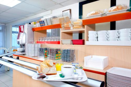a counter in a restaurant with a tray of food at Premiere Classe Gueret in Guéret