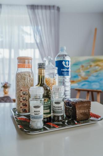 a tray with bottles and other food items on a table at Baltic Sea Dunes Apartments in Jūrmala