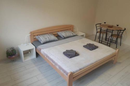 a bedroom with a bed and a table with chairs at Apartman Mima in Belgrade