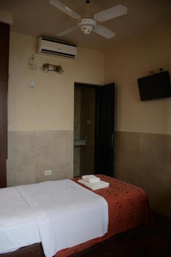 Ένα ή περισσότερα κρεβάτια σε δωμάτιο στο Hotel Santa Cruz