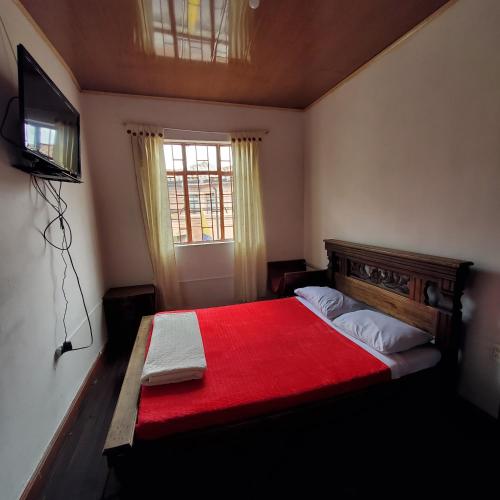 Una cama o camas en una habitación de Hostal CQ Chapinero
