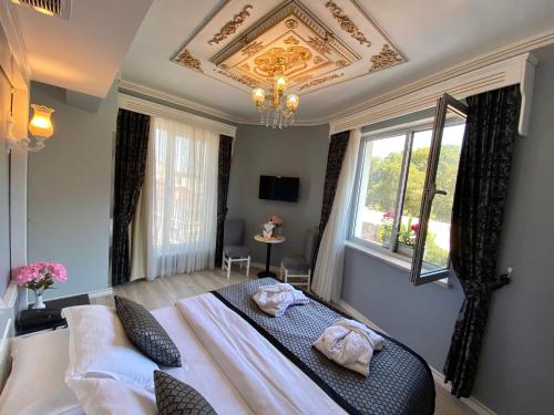 a bedroom with a bed and a chandelier at Gülhanepark Hotel & Spa in Istanbul