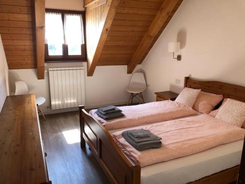 a bedroom with a large bed with pink sheets at La Pioda Vigezzo Santa Maria Maggiore Locazione Turistica in Santa Maria Maggiore