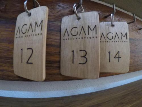 a group of wooden tags on a wall at AGAM Hotel Boutique Bacalar - Adults Only in Bacalar