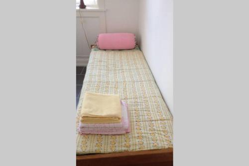 a room with a bed with two towels on it at Sundbyvestervarehus in Copenhagen