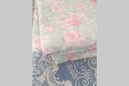 a stack of pink roses on a bed at Sundbyvestervarehus in Copenhagen