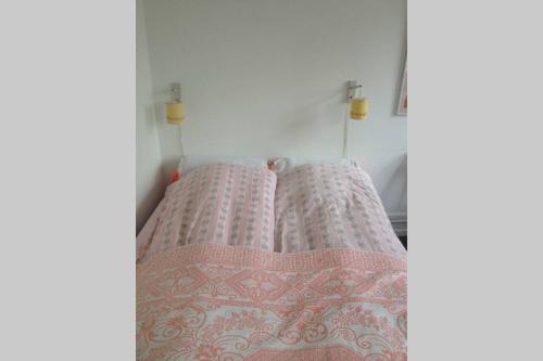 two pillows on a bed in a room at Sundbyvestervarehus in Copenhagen