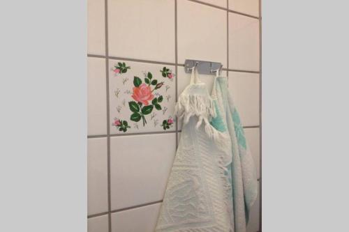 a wedding dress hanging on a rack in a bathroom at Sundbyvestervarehus in Copenhagen
