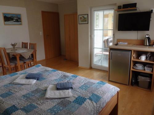 a bedroom with a bed with two towels on it at Pension Dagmar Tauplitz in Tauplitz