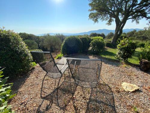 a pair of chairs sitting in a garden at Il Falco - Rustico-Villa mit privatem Pool in Alleinlage in Caldana