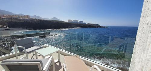 a balcony with chairs and a view of the ocean at Stunning Sea View FREE WIFI in Callao Salvaje