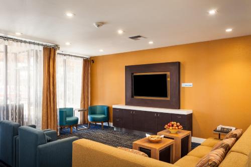 a living room with a couch and a tv at Holiday Inn Express at Monterey Bay by IHG in Seaside