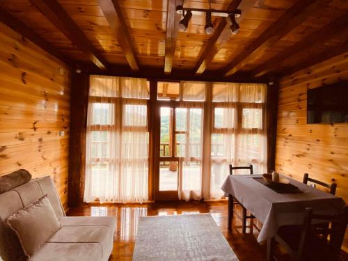 a living room with a couch and a table at FERN FARM ECO RESORT in Mojkovac