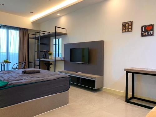 a bedroom with a bed and a flat screen tv at Imperio,Res - Stylish -- Magnificent -- Seaview in Melaka