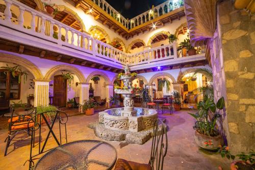 a room with a table and chairs in a building at Hotel Gran Plaza Euromaya in Antigua Guatemala