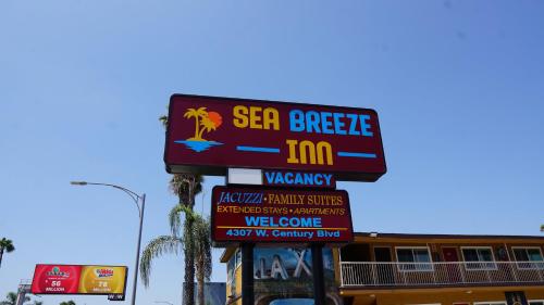 a sign for a sea breeze inn on a street at Sea Breeze Inn - LAX Airport, Los Angeles in Inglewood