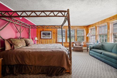 a bedroom with a bed and a couch and a chair at Whitney's Inn in Jackson
