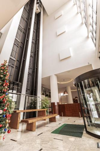 a christmas tree in the lobby of a building at Hotel Inter Cuiaba in Cuiabá