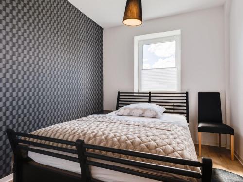 a bedroom with a bed and a window and a chair at Spacious Family Haven in Kröpelin in Kröpelin