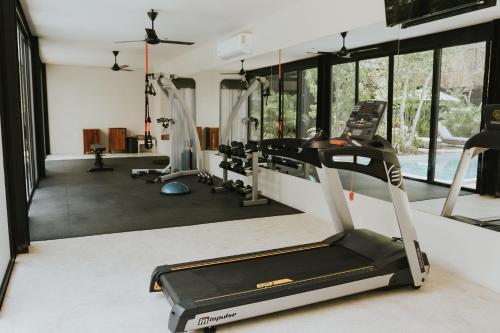 a gym with cardio equipment and a treadmill at Mudra Tulum in Tulum