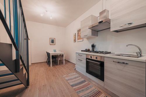 a kitchen with a sink and a stove top oven at Casale di Nicolò in Urbino