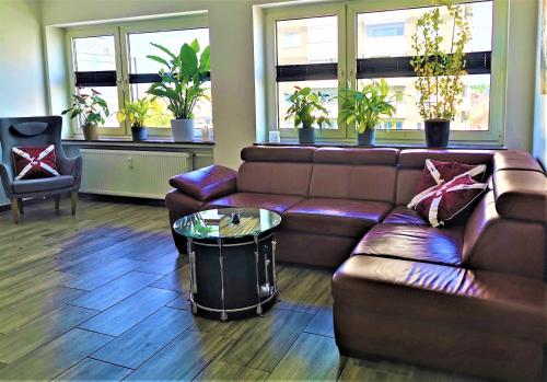 a living room with a leather couch and a table at Bremen City in Bremen