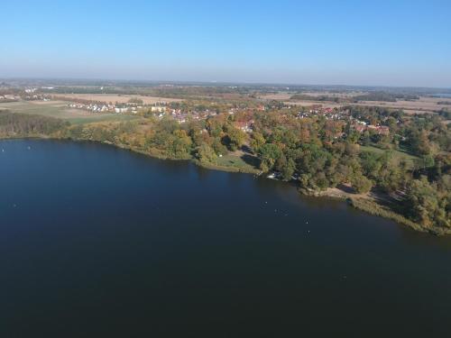 an aerial view of a large lake with trees and houses at Landgasthof Alter Krug Potsdam OT Marquardt in Potsdam