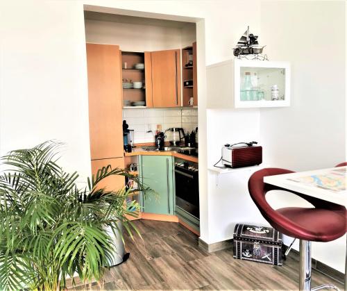 a kitchen with a red chair and a table at Bremen City in Bremen
