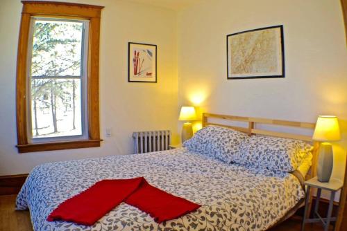 a bedroom with a bed with a red object on it at The Craftsman Farmhouse with Modern Flair in Bethlehem