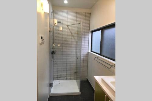 a bathroom with a shower and a sink at Iida Accommodation in Iida