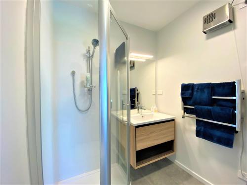 a bathroom with a shower and a sink and a shower at Addictive View - Lakeside Studio in Rotorua