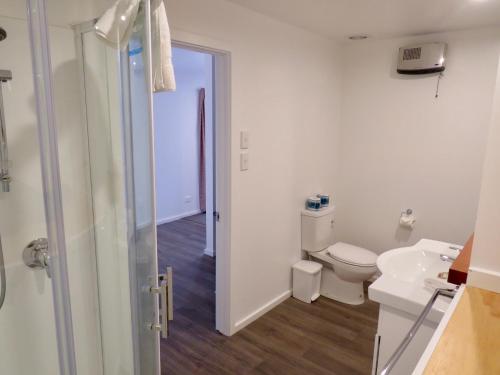 a white bathroom with a toilet and a sink at Korokipo - Lake Tekapo in Lake Tekapo