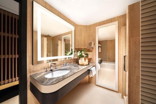 a bathroom with a sink and a mirror at PARKROYAL COLLECTION Marina Bay, Singapore in Singapore