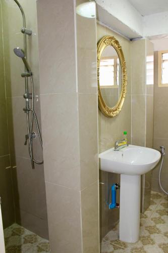 a bathroom with a sink and a shower with a mirror at C U Again in Bangkok