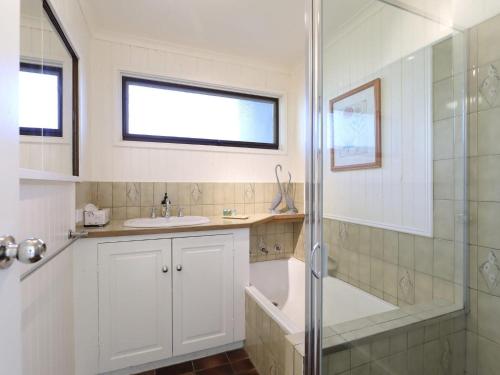 a bathroom with a sink and a shower at Back Beach Hideaway in Blairgowrie