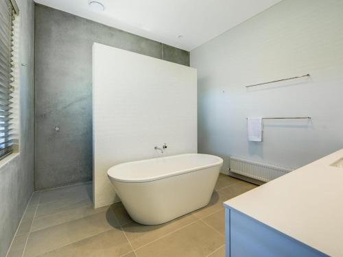 a bathroom with a white tub and a sink at Amagansett in Sorrento