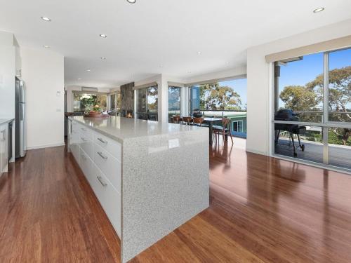 an open kitchen with a large island with a counter top at Bella Vista in McCrae