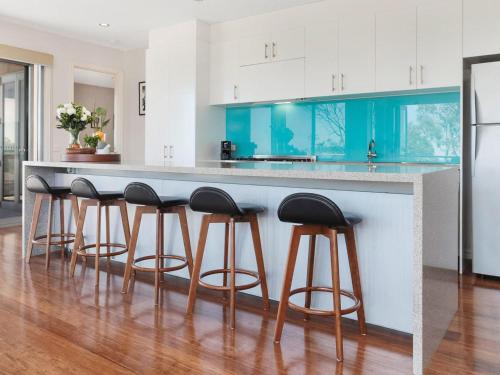 a kitchen with a counter with stools around it at Bella Vista in McCrae