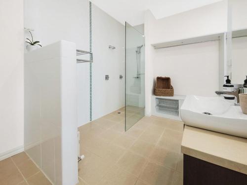 a bathroom with a sink and a glass shower at Bella Vista in McCrae