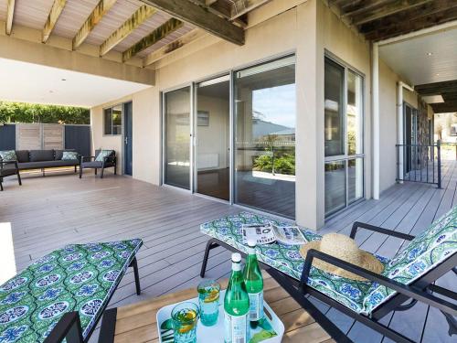 a patio with a table and chairs on a deck at Bella Vista in McCrae