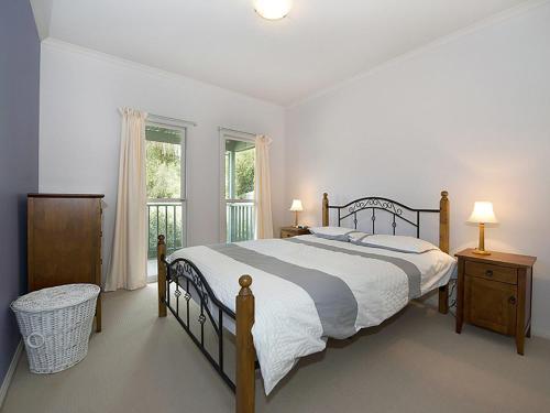 a bedroom with a large bed and a window at Poolside Sorrento in Sorrento