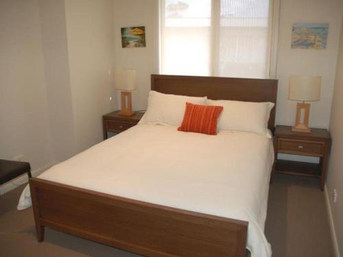 a bedroom with a large bed with two night stands at Sorrento City Style in Sorrento