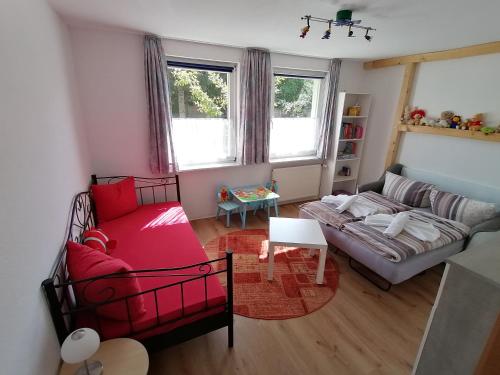 een woonkamer met een rode bank bij Ferienwohnung am Haffberg in Neverow