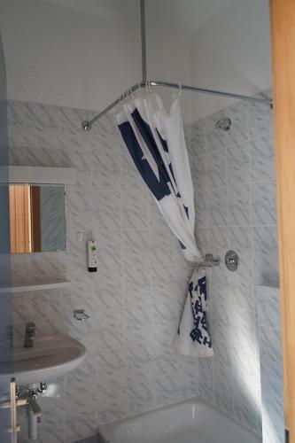 a bathroom with a sink and a shower with an umbrella at Mont-Fort Swiss Lodge in Le Châble