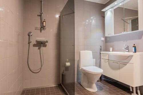 a bathroom with a shower and a toilet and a sink at Saimaa Life Apartments in Imatra