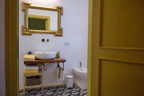 a bathroom with a sink and a mirror on the wall at OlioeAlloro B&B in San Vincenzo